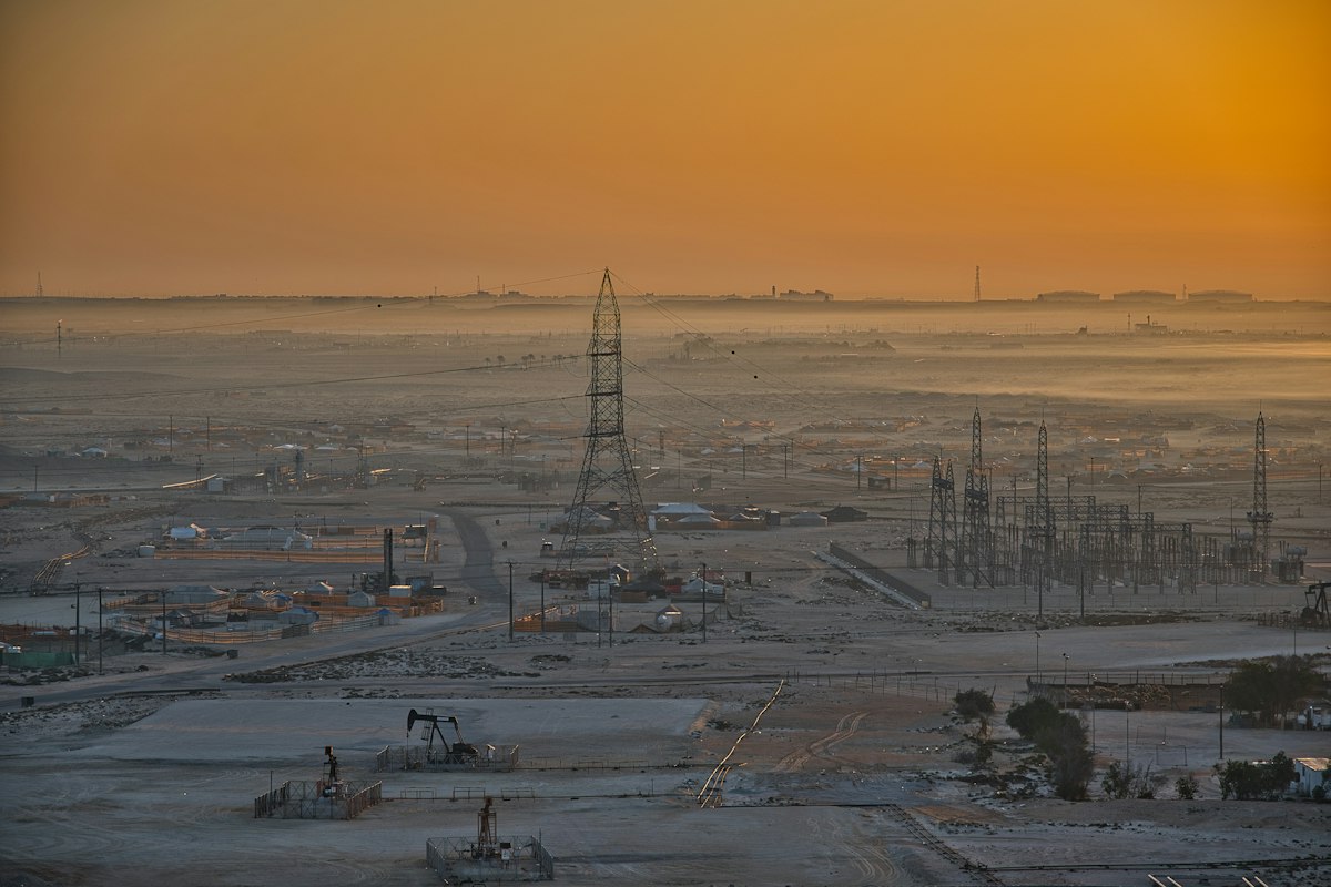 Onshore oil field with pumpjacks in the desert at dawn
